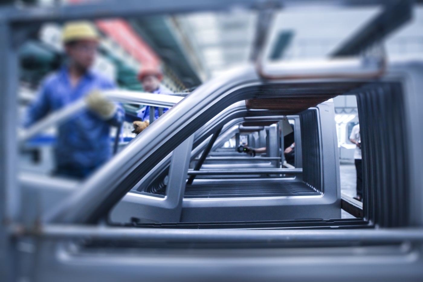 Worker pulling car door off line